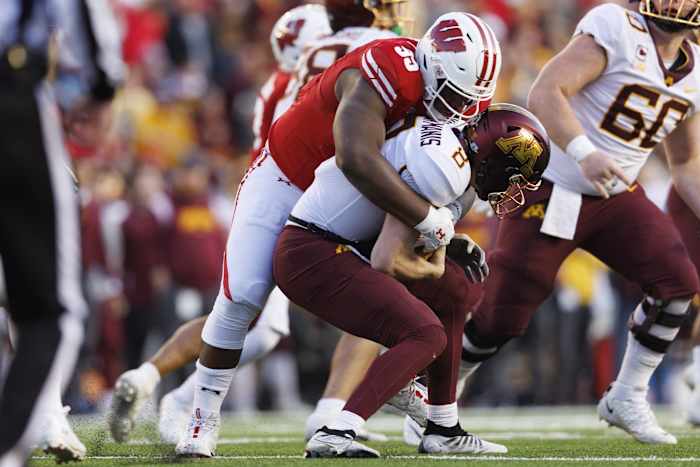 Nov 26, 2022; Madison, Wisconsin, USA; Wisconsin Badgers nose tackle Keeanu Benton (95) sacks Minnesota Golden Gophers quarterback Athan Kaliakmanis (8) during the second quarter at Camp Randall Stadium. Mandatory Credit: Jeff Hanisch-USA TODAY Sports